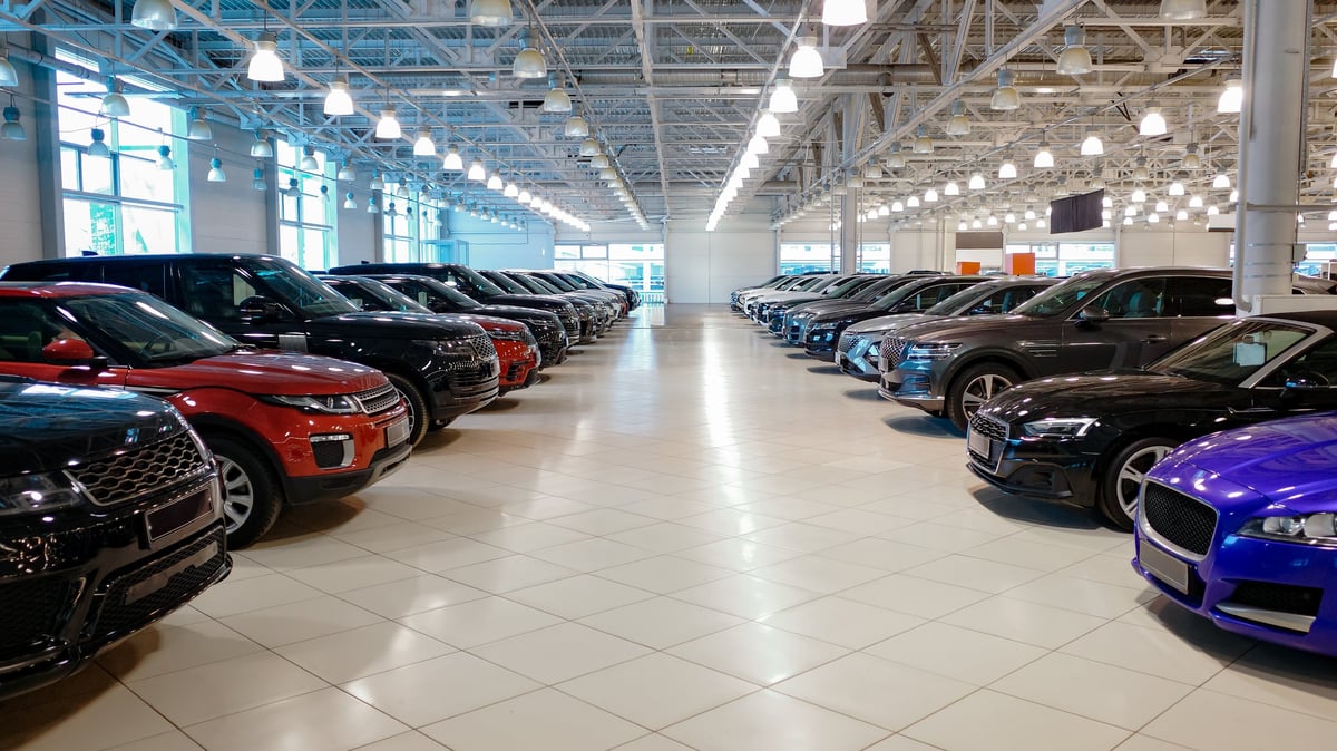 Car Dealership showroom with clean floors and vehicles